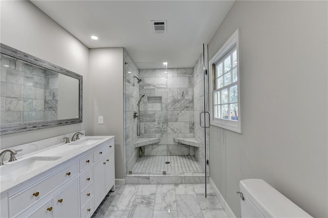 bathroom featuring vanity, toilet, and an enclosed shower