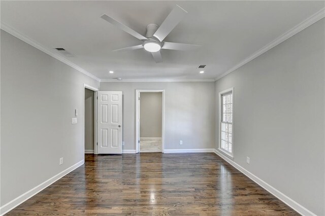 spare room with ceiling fan, ornamental molding, and dark wood-type flooring