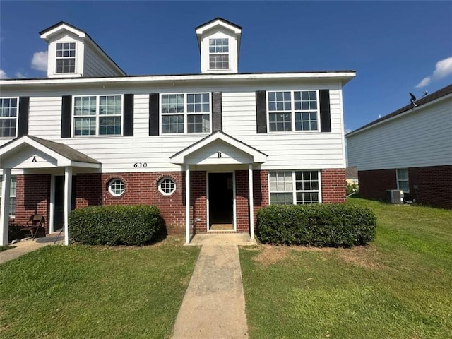 630 Mill Stone Blf Unit B, Monroe, GA 30655 - view of front of home with brick siding and a front lawn