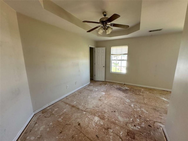 630 Mill Stone Blf Unit B, Monroe, GA 30655 - unfurnished room with a tray ceiling and a ceiling fan