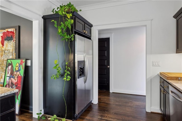 kitchen with dark hardwood / wood-style floors, light stone countertops, ornamental molding, dark brown cabinets, and stainless steel appliances