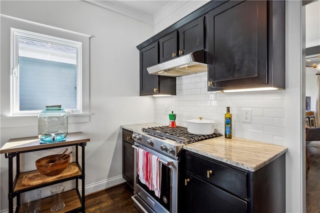 kitchen with decorative backsplash, dark hardwood / wood-style flooring, light stone counters, high end stove, and crown molding