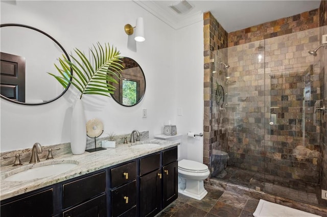 bathroom featuring crown molding, a shower with door, vanity, and toilet