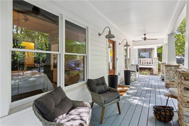 wooden deck with covered porch and ceiling fan