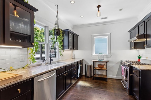 kitchen featuring sink, ornamental molding, pendant lighting, and appliances with stainless steel finishes