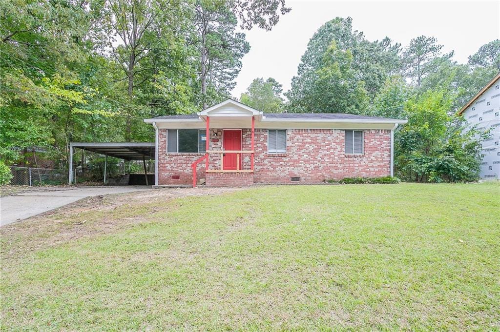 ranch-style home with a carport and a front yard