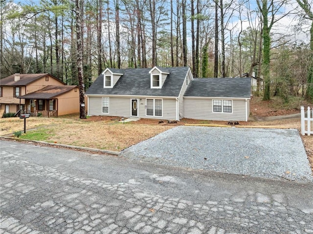 cape cod-style house featuring driveway