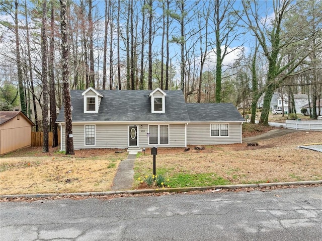 new england style home with fence