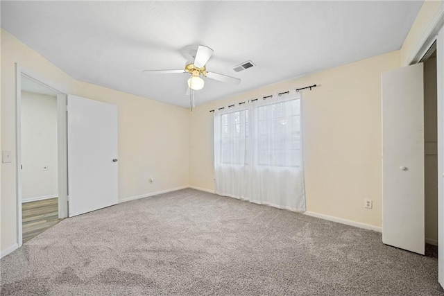 unfurnished bedroom with baseboards, visible vents, ceiling fan, and carpet flooring