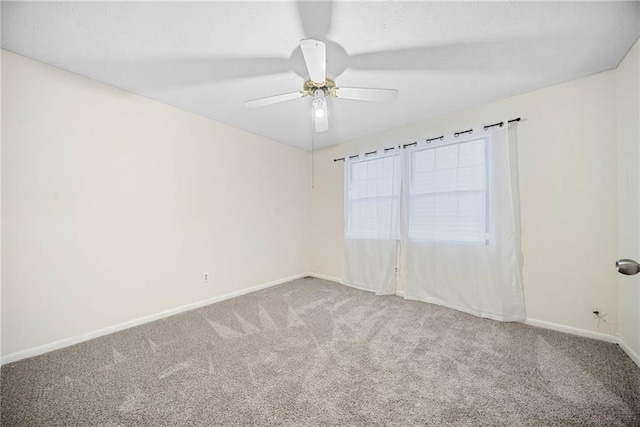 empty room with carpet, ceiling fan, and baseboards