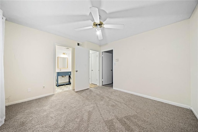 unfurnished bedroom featuring carpet flooring, visible vents, and baseboards