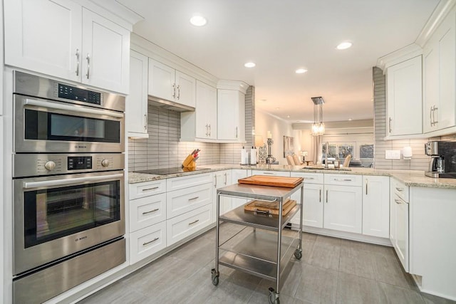 kitchen with black electric stovetop, recessed lighting, backsplash, double oven, and white cabinetry