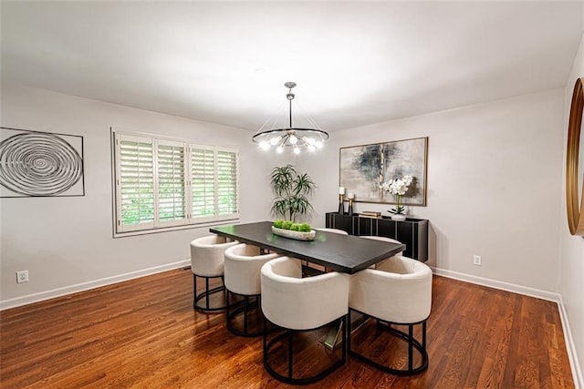 dining room featuring dark wood-style floors, a chandelier, and baseboards