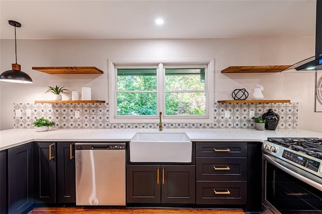 kitchen featuring a sink, stainless steel appliances, open shelves, and light countertops