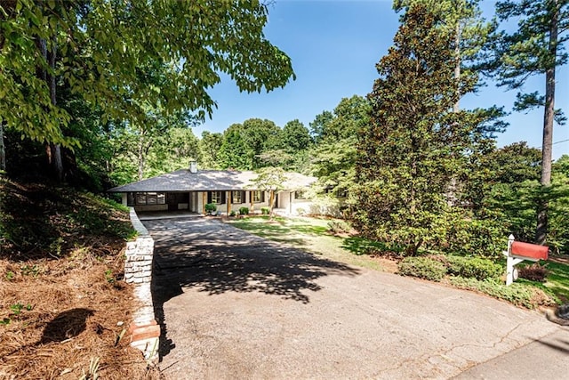 view of front of home with driveway and a carport