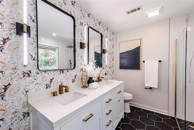 full bath featuring toilet, a sink, visible vents, and wallpapered walls