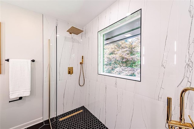 bathroom with a marble finish shower