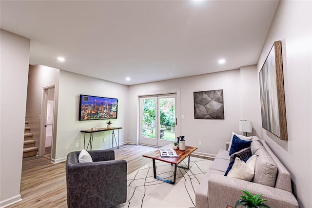 living room featuring stairway, recessed lighting, light wood-style flooring, and baseboards