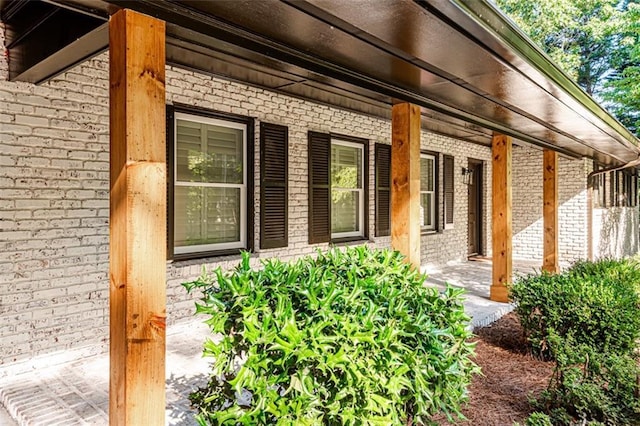 view of home's exterior featuring covered porch and brick siding