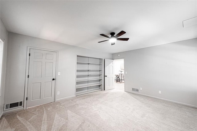 unfurnished bedroom with ceiling fan, carpet flooring, visible vents, baseboards, and a closet