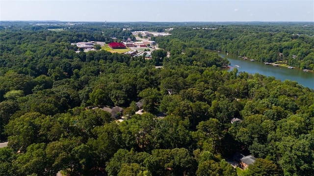 bird's eye view featuring a forest view and a water view