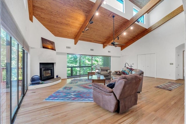 living room featuring beamed ceiling, high vaulted ceiling, ceiling fan, and light hardwood / wood-style floors