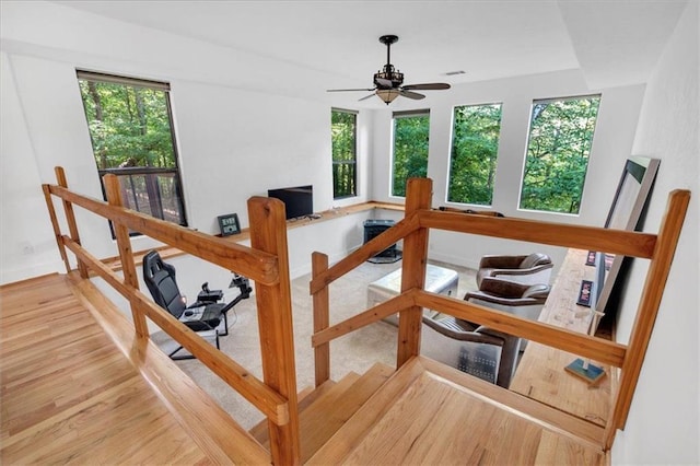 interior space with ceiling fan, hardwood / wood-style flooring, and a healthy amount of sunlight