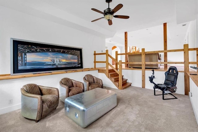 living area with carpet flooring and ceiling fan