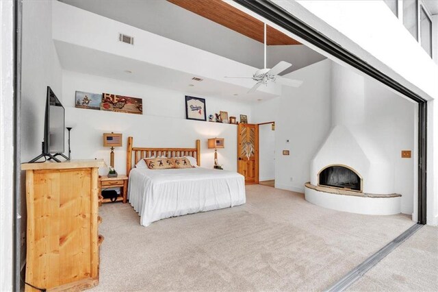 carpeted bedroom featuring a high ceiling and ceiling fan