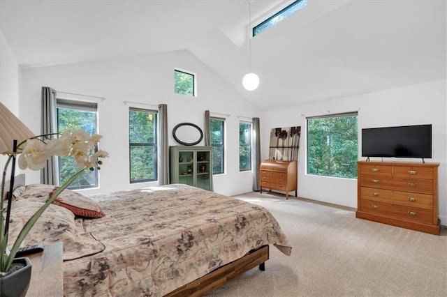 carpeted bedroom with high vaulted ceiling