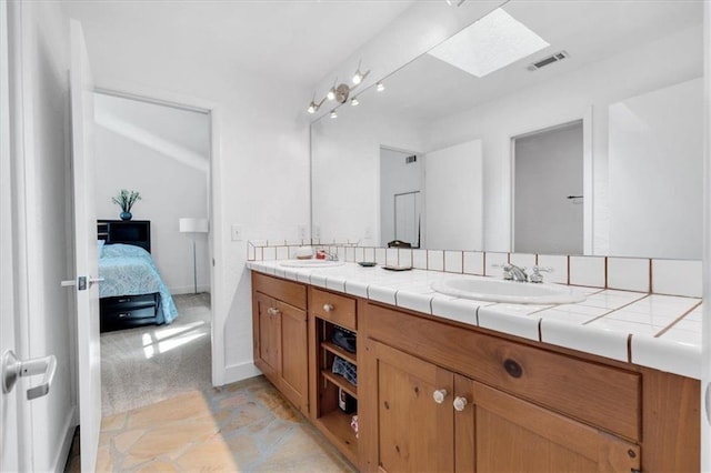 bathroom with vanity and a skylight