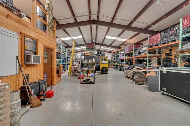 interior space featuring cooling unit, wooden walls, and a workshop area