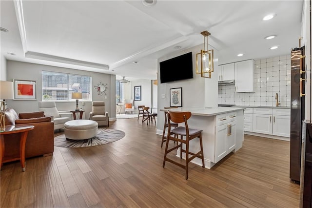 215 Piedmont Ave NE Unit 506, Atlanta, GA 30308 - kitchen featuring white cabinets, open floor plan, light countertops, and a kitchen island