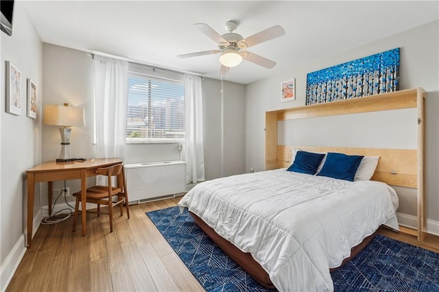 215 Piedmont Ave NE Unit 506, Atlanta, GA 30308 - bedroom with ceiling fan, baseboards, and wood finished floors