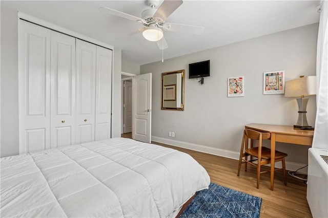 215 Piedmont Ave NE Unit 506, Atlanta, GA 30308 - bedroom featuring a closet, baseboards, a ceiling fan, and wood finished floors
