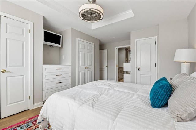 215 Piedmont Ave NE Unit 506, Atlanta, GA 30308 - bedroom with a raised ceiling, crown molding, baseboards, and light wood-style flooring