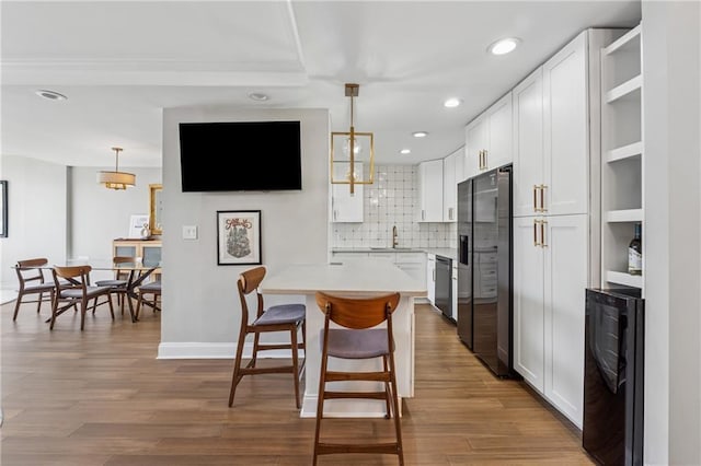 215 Piedmont Ave NE Unit 506, Atlanta, GA 30308 - kitchen featuring black appliances, white cabinets, open shelves, and beverage cooler