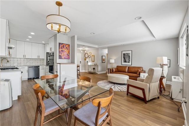 215 Piedmont Ave NE Unit 506, Atlanta, GA 30308 - dining area with baseboards, a chandelier, and wood finished floors