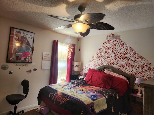 bedroom with ceiling fan and a textured ceiling