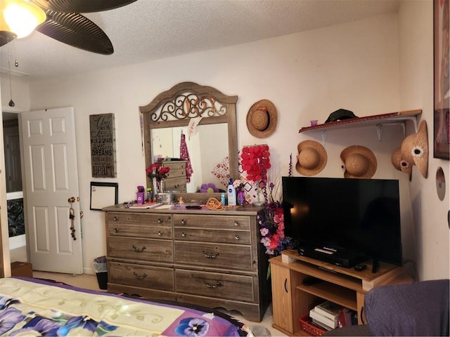 bedroom featuring ceiling fan and a textured ceiling