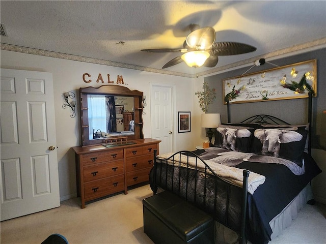 carpeted bedroom featuring a textured ceiling and ceiling fan