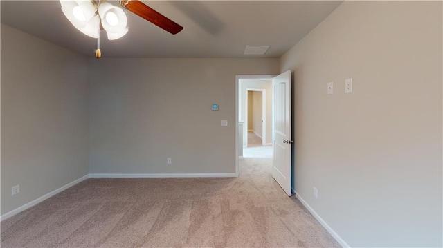 unfurnished room featuring light carpet, a ceiling fan, and baseboards