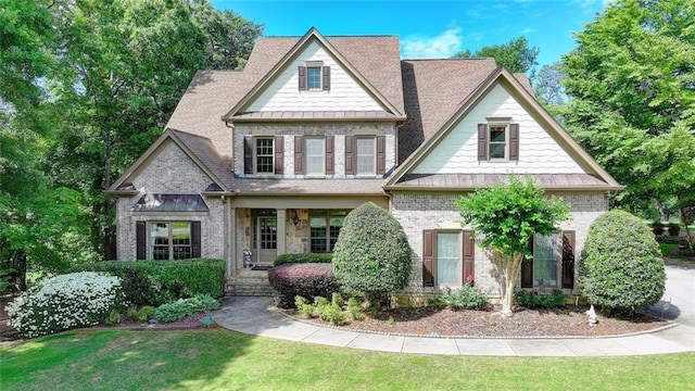 4478 Longmead Rd, Flowery Branch, GA 30542 - view of front of home with brick siding, a front yard, a standing seam roof, a porch, and roof with shingles
