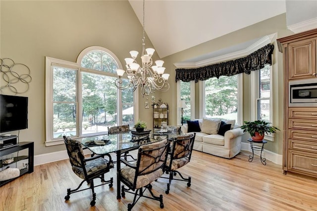4478 Longmead Rd, Flowery Branch, GA 30542 - dining area with high vaulted ceiling, baseboards, a chandelier, and light wood finished floors