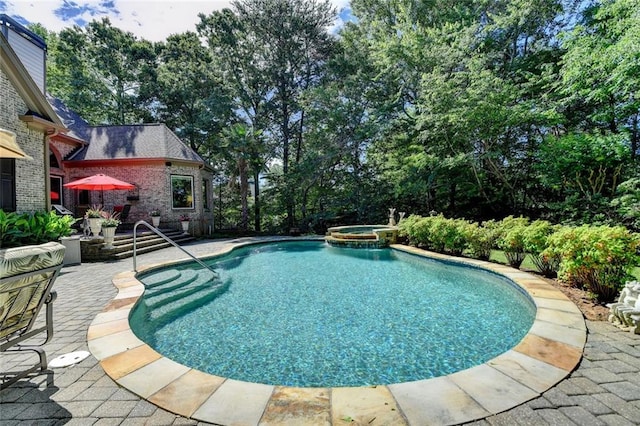 4478 Longmead Rd, Flowery Branch, GA 30542 - view of swimming pool featuring a patio area, a pool with connected hot tub, and view of wooded area