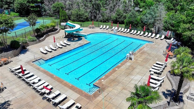 4478 Longmead Rd, Flowery Branch, GA 30542 - community pool featuring a water slide, a patio area, and view of scattered trees