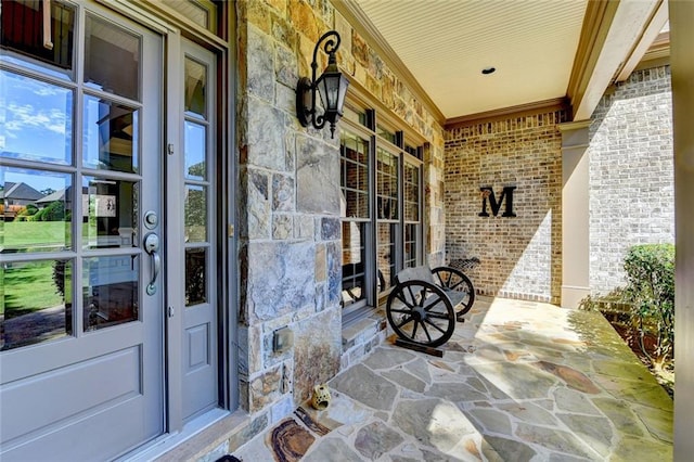 4478 Longmead Rd, Flowery Branch, GA 30542 - entrance to property featuring stone siding, covered porch, brick siding, and french doors