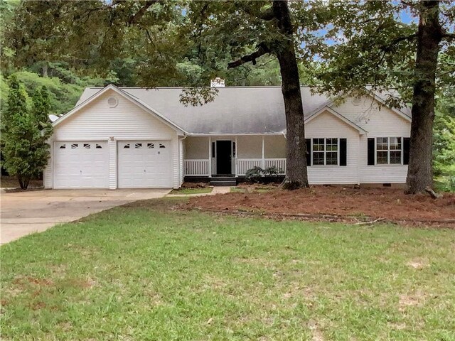 ranch-style home featuring a porch, a garage, and a front lawn