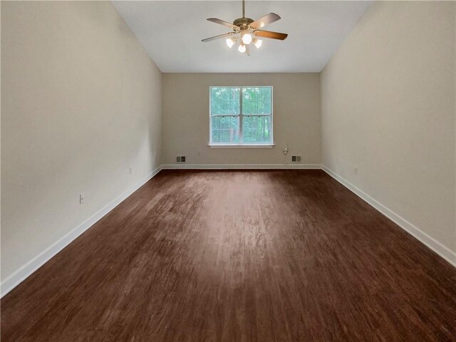 spare room with ceiling fan and dark hardwood / wood-style floors