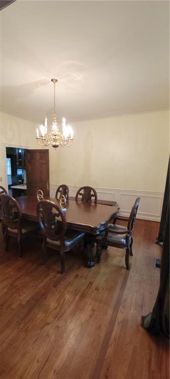 dining space with an inviting chandelier and dark wood finished floors